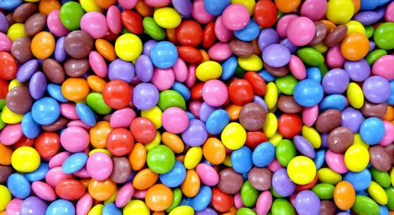 Close-up of colorful candy-coated chocolates scattered together