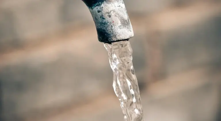 Close-up of water streaming from a faucet